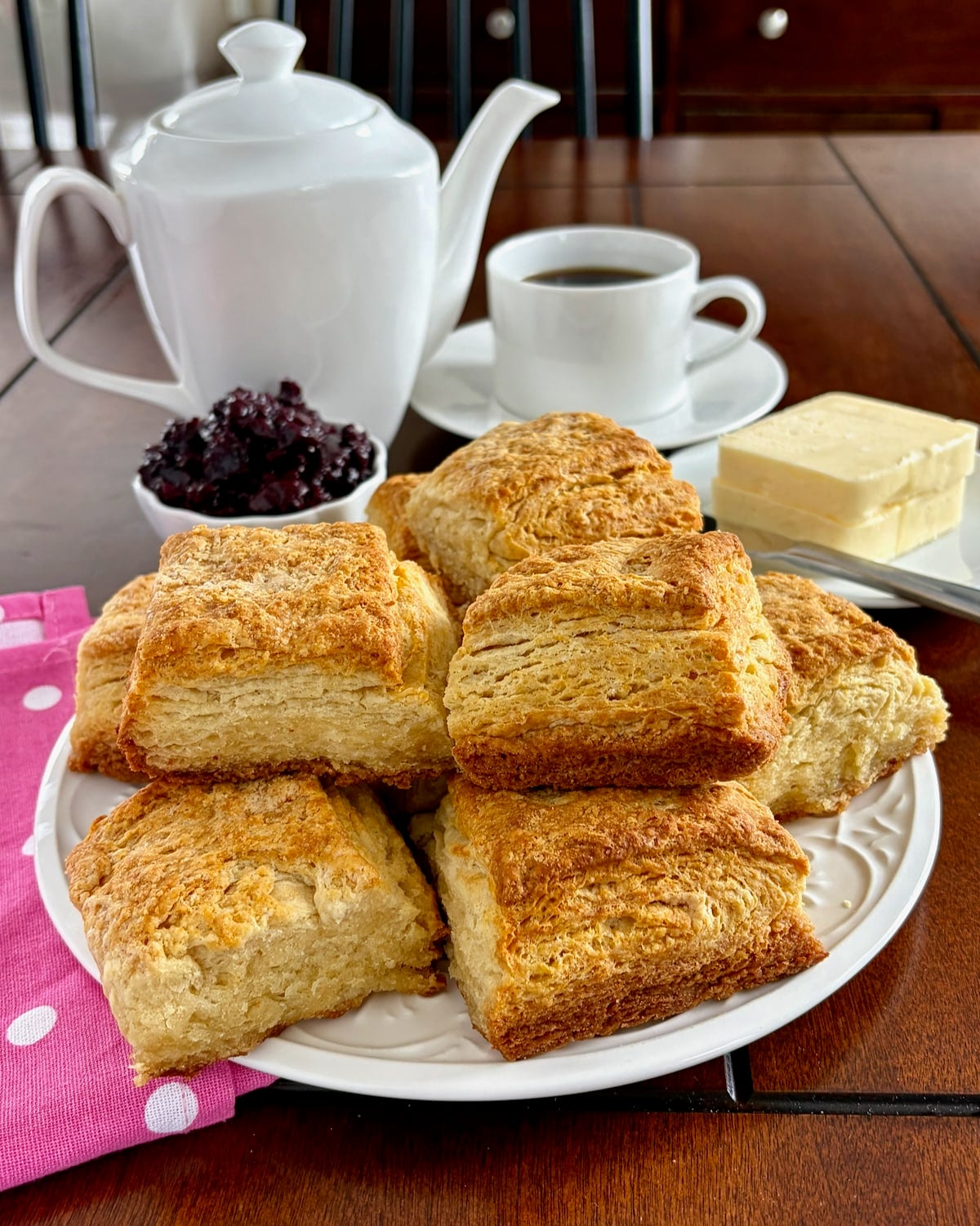 Flaky Sour Cream Biscuits on a white serving plate.
