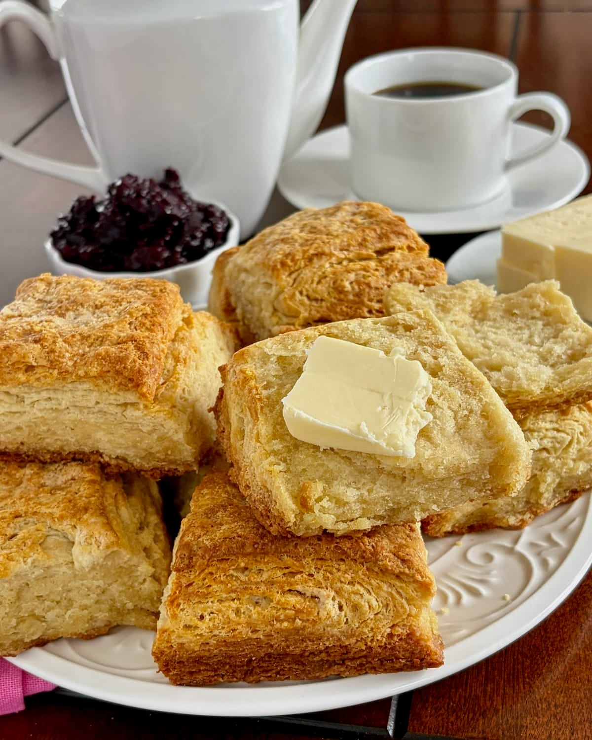Close up photo of one buttered biscuit.