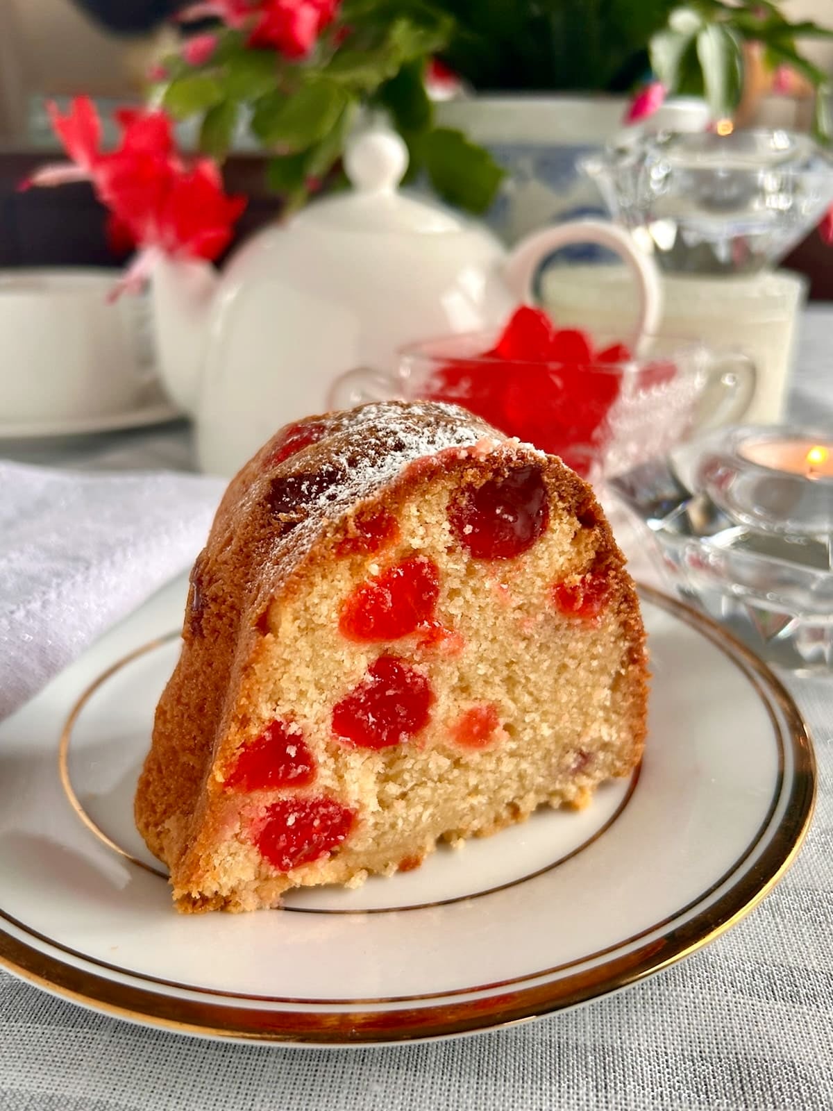 Close up photo of one slice of Swedish Berry Pound Cake on a gold and white plate formatted size for social media posts.