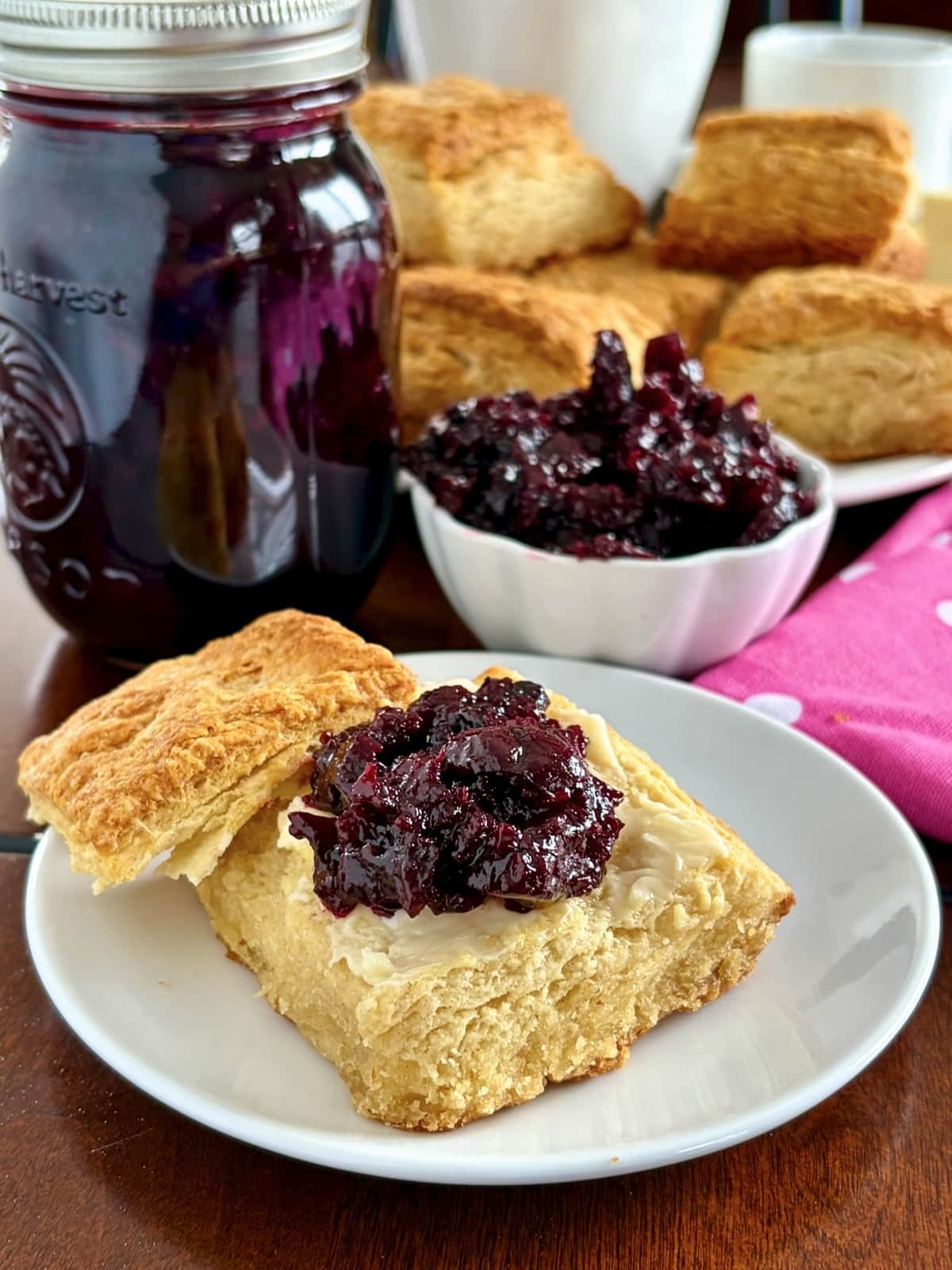 Wide shot of Low Sugar Blueberry Cherry Jam. on biscuits with cffee service