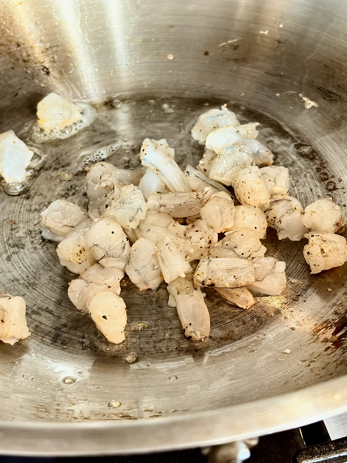 Photo of shrimp being added to hot wok.