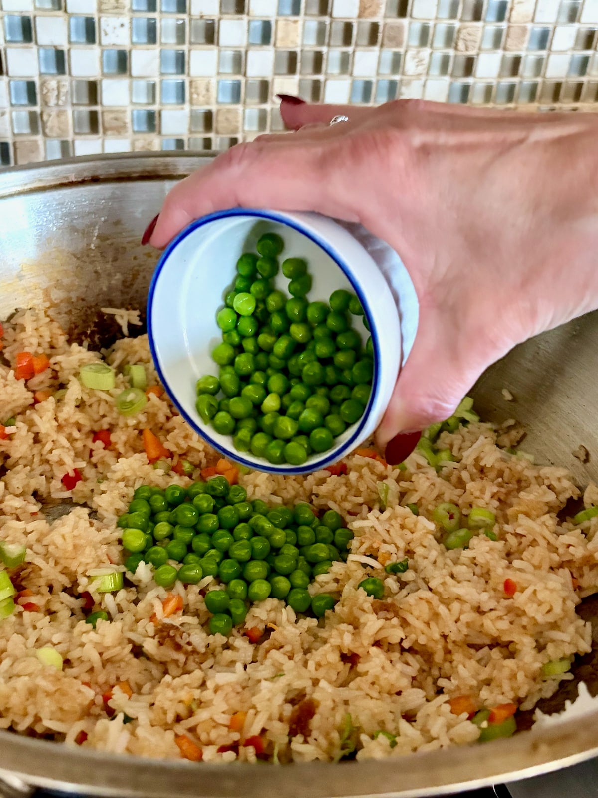 Photo of adding the peas to the wok.