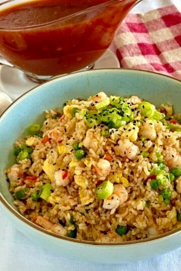 Shrimp fried rice in a blue serving bowl.