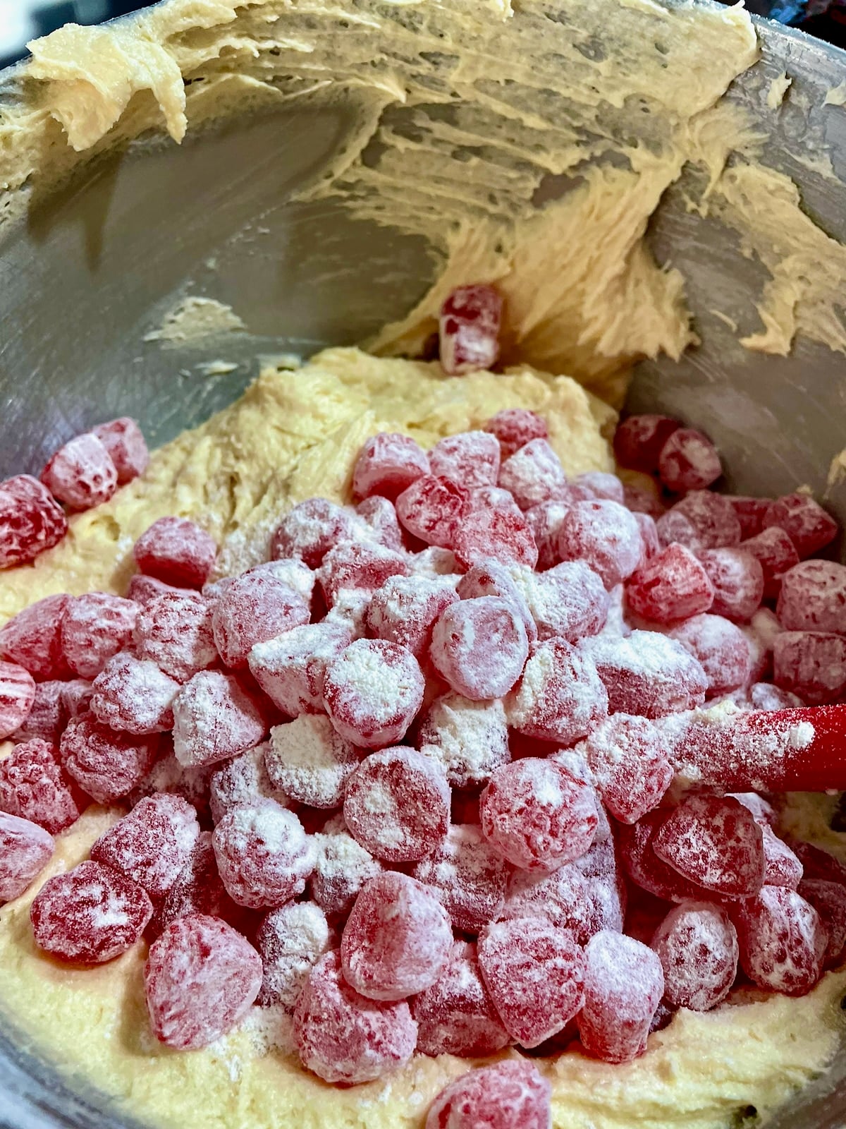 Photo of flour coated candy being added to the cake batter.