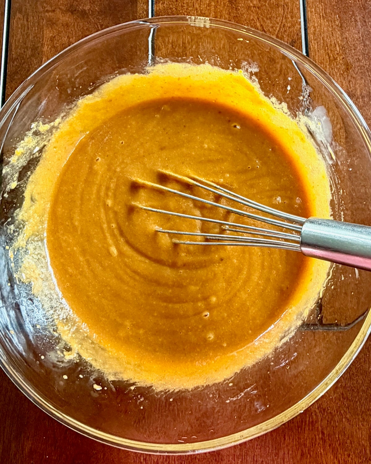photo of pumpkin puree, oil and eggs whisked together.