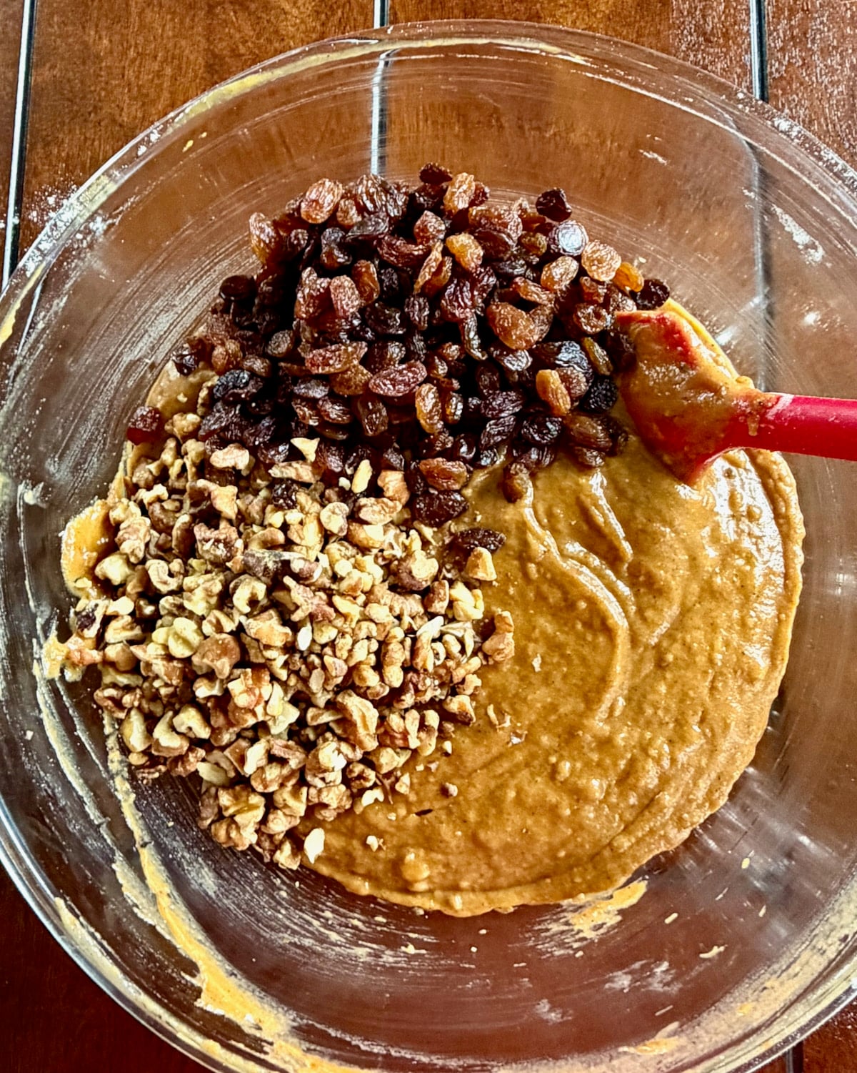 Photo of walnuts and raisins being added to the batter.
