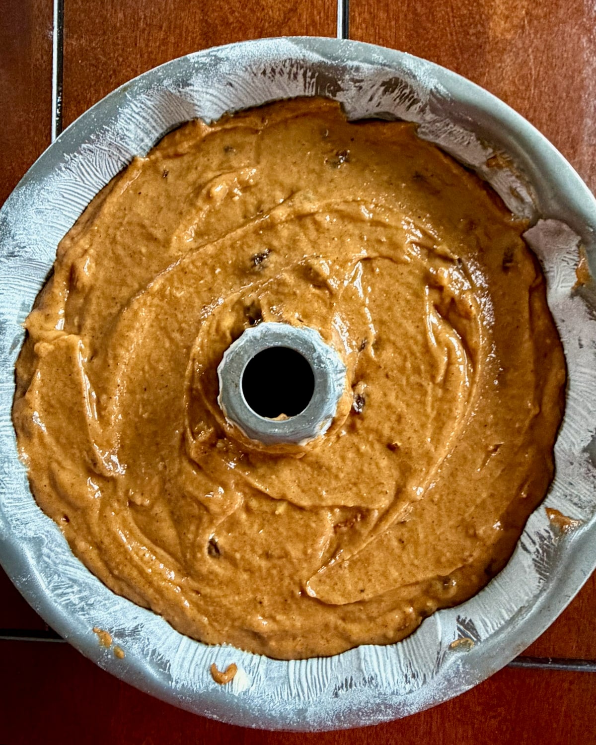 Photo of batter added to prepared bundt pan.