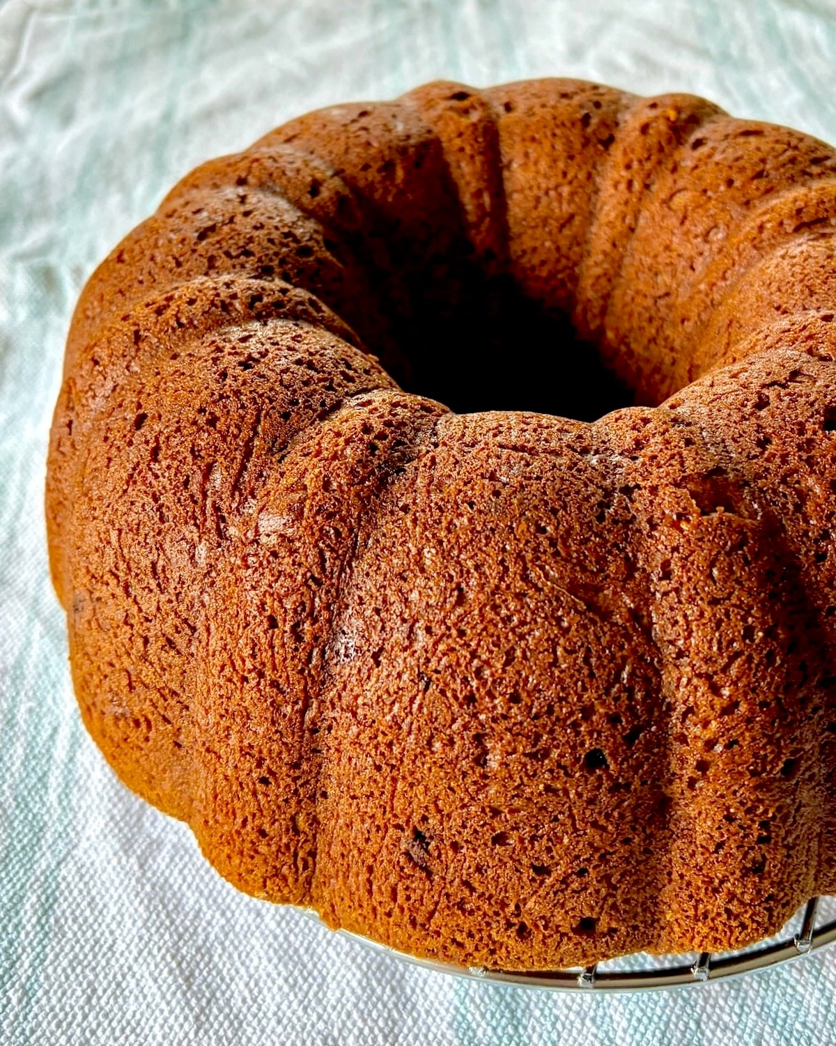 photo of inverted cake cooling on a baking rack