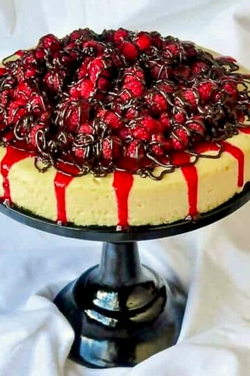 Raspberry Tuxedo Cheesecake shown as a Halloween Party dessert, Dracula's Blood Cheesecake.