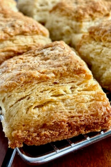Close up photo of Flaky Sour Cream Biscuits cooling in a wire rack.