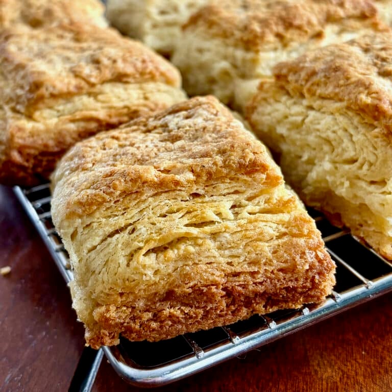Close up photo of Flaky Sour Cream Biscuits cooling in a wire rack.